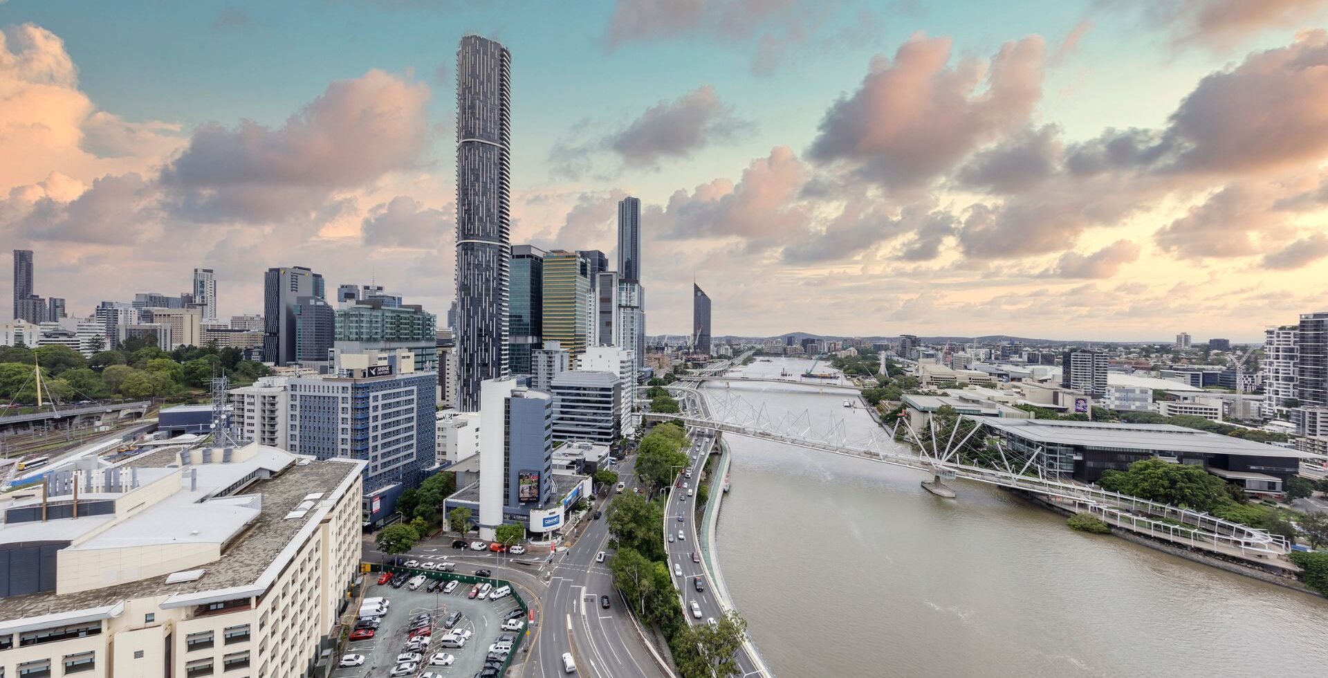 Panoramic view of Brisbane skyline at dusk, featuring the Brisbane River